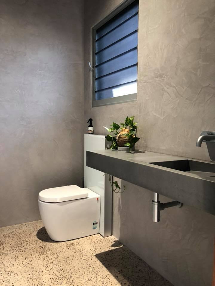 Powder room with grey textured walls, a concrete-look vanity and terrazzo floor