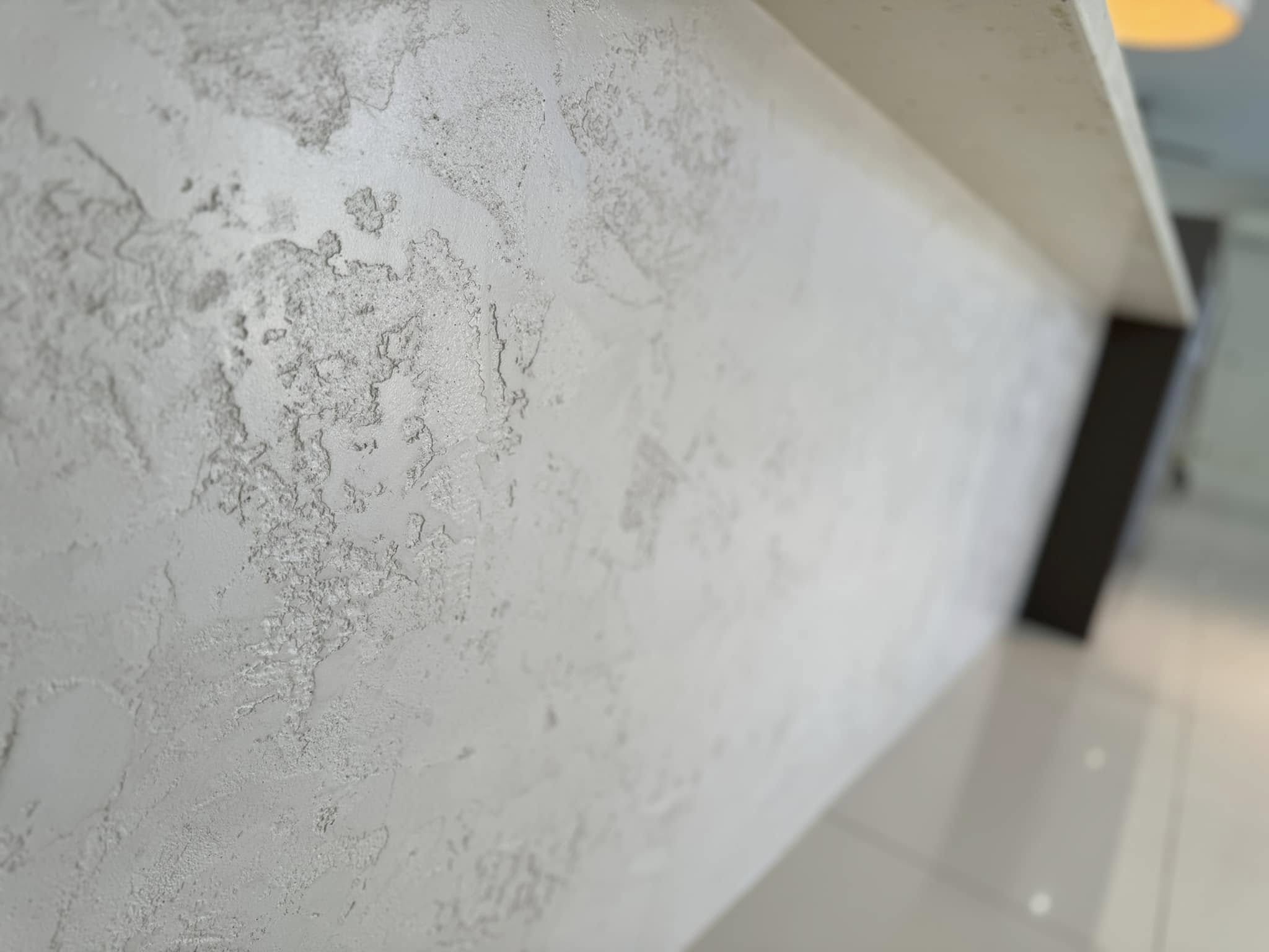 Close-up of a mottled white trowelled finish on a benchtop edge