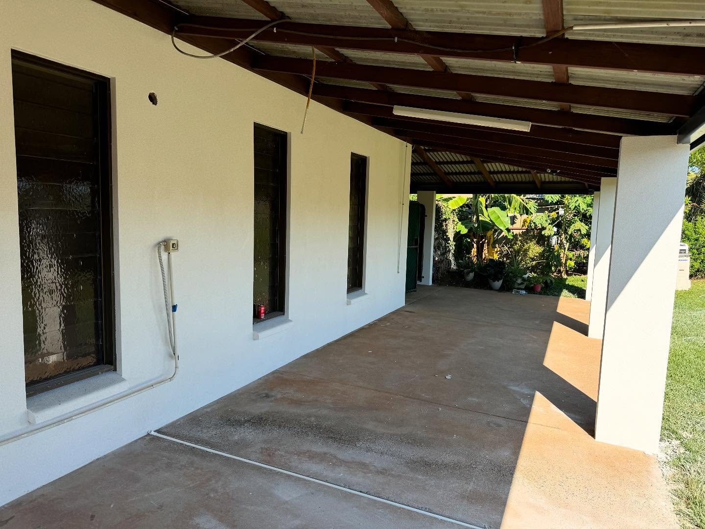 Covered verandah with smooth white rendered walls and columns