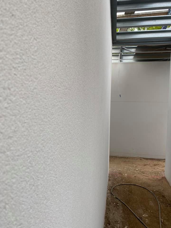 Close-up of a white textured rendered column