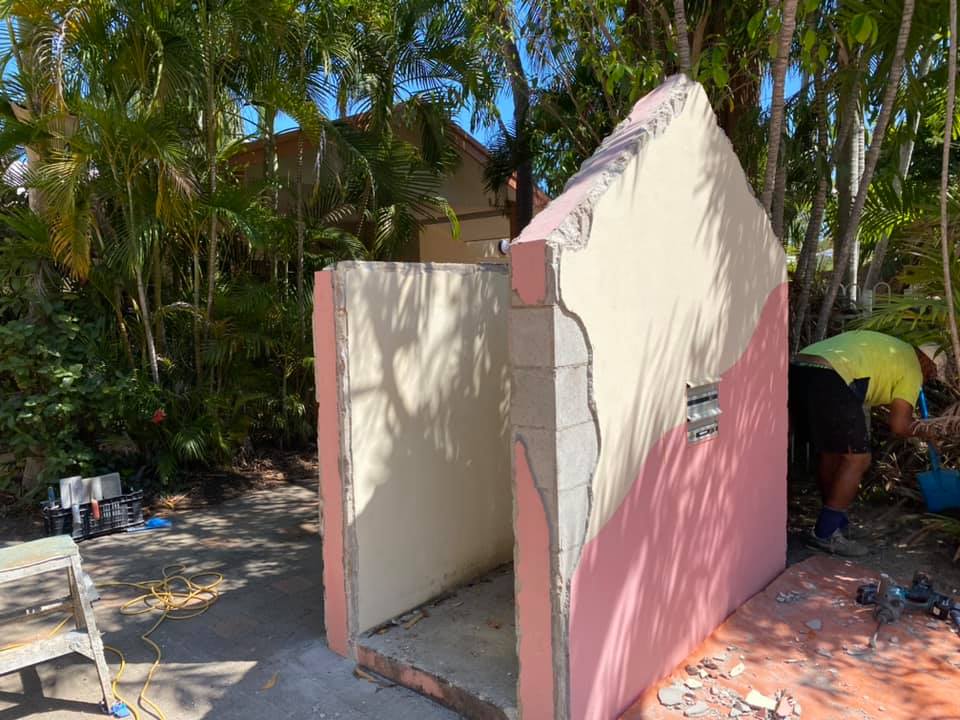 Before: damaged, patchy render on a small outdoor wall structure